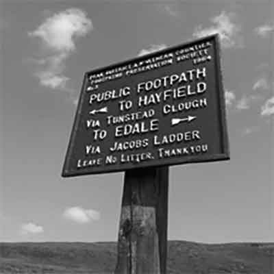 A distant horizon and sky, now with a cast metal sign in the foreground