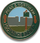 Stamped metal pin badge showing our old logo