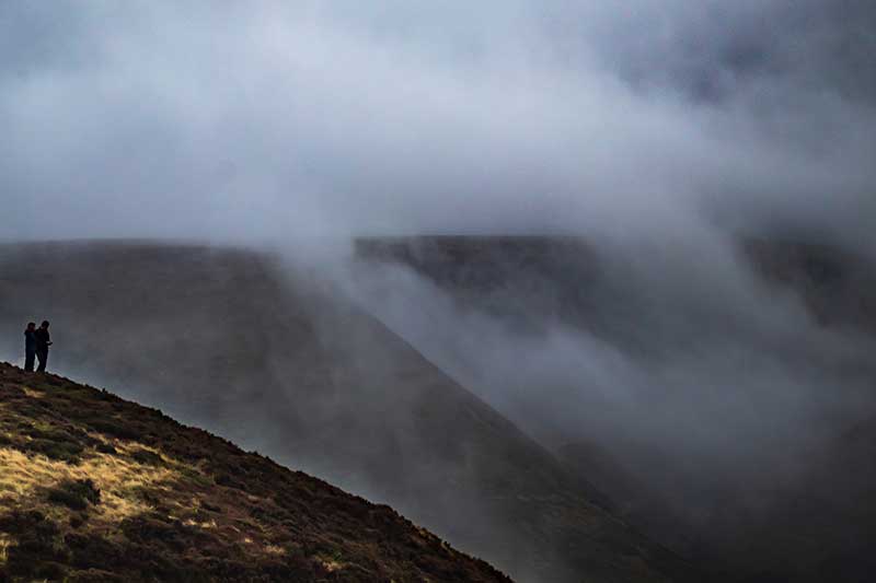 A view across a foggy landscape with bearely visible hills